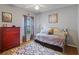 Comfortable secondary bedroom with decorative rug, dresser and natural light through the window at 4608 Kilcoyne Ct, Lutz, FL 33558