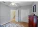 Neutral toned secondary bedroom features wainscotting, closet doors, and access to the staircase at 4608 Kilcoyne Ct, Lutz, FL 33558