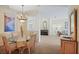 Open concept dining room with chandelier, artwork and views of living areas of the home at 4608 Kilcoyne Ct, Lutz, FL 33558