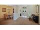 Open concept dining room with chandelier, grand entryway and decorative pillars at 4608 Kilcoyne Ct, Lutz, FL 33558