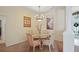 Dining room featuring a chandelier, artwork and sunlit views to the front of the home at 4608 Kilcoyne Ct, Lutz, FL 33558