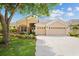 Charming home featuring a three car garage, manicured lawn, stone accents and mature tree at 4608 Kilcoyne Ct, Lutz, FL 33558