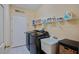 This laundry room includes a utility sink, washer, dryer, and shelving at 4608 Kilcoyne Ct, Lutz, FL 33558