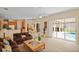 Spacious living room with sliding doors to the patio and pool, adjacent to the kitchen and dining area at 4608 Kilcoyne Ct, Lutz, FL 33558