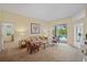 Inviting living room with plush carpet and a view to screened in pool in backyard at 4608 Kilcoyne Ct, Lutz, FL 33558