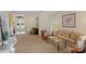 Cozy living room with plush carpet, plenty of sunlight and open view to the entryway at 4608 Kilcoyne Ct, Lutz, FL 33558