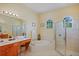Bright main bathroom with garden tub, glass shower, double sinks, makeup vanity, and natural light at 4608 Kilcoyne Ct, Lutz, FL 33558