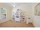 Bright home office with a large window, bookshelves, and exercise equipment at 4608 Kilcoyne Ct, Lutz, FL 33558