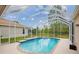 This refreshing screened-in pool is surrounded by greenery at 4608 Kilcoyne Ct, Lutz, FL 33558