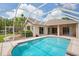 Relaxing pool in a screened-in lanai with views of the lush landscaping at 4608 Kilcoyne Ct, Lutz, FL 33558