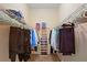 Walk-in closet with wire shelving and carpet flooring provides ample storage space for clothing and shoes at 4608 Kilcoyne Ct, Lutz, FL 33558
