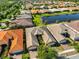 Beautiful aerial view of the residential neighborhood featuring well-maintained homes, lush landscaping and a tranquil pond at 4961 Marble Springs Cir, Wimauma, FL 33598