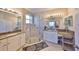 Bathroom featuring dual sinks, a glass-enclosed shower and neutral color palette at 4961 Marble Springs Cir, Wimauma, FL 33598