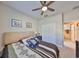 Bedroom featuring a ceiling fan, closet and an en-suite bathroom access at 4961 Marble Springs Cir, Wimauma, FL 33598
