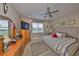 Cozy bedroom with a large window offering an outdoor view, and traditional furniture at 4961 Marble Springs Cir, Wimauma, FL 33598