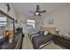 Bedroom with a ceiling fan, window, and traditional furniture set at 4961 Marble Springs Cir, Wimauma, FL 33598