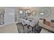 Dining room showcases unique mirrors, a modern chandelier, and space for entertaining at 4961 Marble Springs Cir, Wimauma, FL 33598