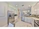 Contemporary kitchen with stainless steel appliances, granite counters, and open layout into the living area at 4961 Marble Springs Cir, Wimauma, FL 33598