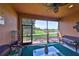 Inviting screened lanai offers comfortable seating and lovely backyard vistas at 4961 Marble Springs Cir, Wimauma, FL 33598