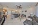 Open-concept living room with tile flooring seamlessly connects to the dining area at 4961 Marble Springs Cir, Wimauma, FL 33598