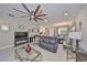 Living room featuring tile floors, a ceiling fan, and views to the kitchen and dining areas at 4961 Marble Springs Cir, Wimauma, FL 33598