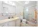 A full bathroom features a single sink vanity, toilet, and shower with glass doors at 5660 80Th N St # D207, St Petersburg, FL 33709