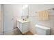 A bathroom features a tiled wall, a toilet, a vanity, and a mirror at 5660 80Th N St # D207, St Petersburg, FL 33709