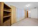 Bedroom with natural light, a large window with curtains, and a wooden bookshelf at 5660 80Th N St # D207, St Petersburg, FL 33709