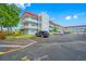 Beautiful landscaping surrounds this condominium complex with a bright blue sky at 5660 80Th N St # D207, St Petersburg, FL 33709