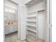 Walk-in closet with shelving, connecting to the bathroom at 5660 80Th N St # D207, St Petersburg, FL 33709