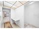 Hallway with light walls and floors leading into an adjoining room at 5660 80Th N St # D207, St Petersburg, FL 33709