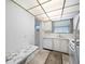Galley kitchen featuring a dishwasher, sink and a marble countertop workstation at 5660 80Th N St # D207, St Petersburg, FL 33709
