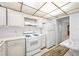 Clean, bright kitchen featuring white appliances, granite counters, and ample storage at 5660 80Th N St # D207, St Petersburg, FL 33709
