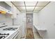 Kitchen with view of the living area and a compact workspace with granite countertop at 5660 80Th N St # D207, St Petersburg, FL 33709