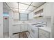 Charming kitchen featuring white appliances, cabinets, sink, and countertops with good natural light at 5660 80Th N St # D207, St Petersburg, FL 33709