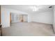 Bright living room with a ceiling fan, tan curtains and a large window at 5660 80Th N St # D207, St Petersburg, FL 33709