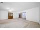 Spacious living room with a ceiling fan and tan curtains at 5660 80Th N St # D207, St Petersburg, FL 33709