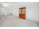 Spacious living room featuring neutral carpet, ceiling fan, and a charming china cabinet at 5660 80Th N St # D207, St Petersburg, FL 33709