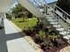 Exterior building view with white stairs surrounded by mulch and flowers, and green lawn at 5875 18Th N St # 19, St Petersburg, FL 33714