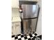 Kitchen with stainless steel refrigerator and ample cabinet space with black and white tile flooring at 5875 18Th N St # 19, St Petersburg, FL 33714
