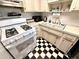 Functional kitchen featuring a gas range, classic black and white floors, and ample counter space at 5875 18Th N St # 19, St Petersburg, FL 33714