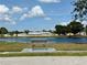 A relaxing pond with a bench and fountain in the background, offering a peaceful outdoor amenity at 5875 18Th N St # 19, St Petersburg, FL 33714
