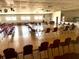 A large recreation hall with tables, chairs, and a stage, ideal for community events and gatherings at 5875 18Th N St # 19, St Petersburg, FL 33714
