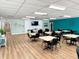 A brightly lit recreation room with tables, chairs, and stylish decor, great for socializing at 5875 18Th N St # 19, St Petersburg, FL 33714