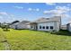 Spacious backyard featuring lush green grass and a covered patio perfect for outdoor relaxation and entertaining at 5979 Hidden Branch Dr, Apollo Beach, FL 33572