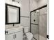 Bathroom features a glass shower door and vanity with white countertop and black hardware at 5979 Hidden Branch Dr, Apollo Beach, FL 33572