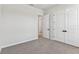 Neutral-toned bedroom with carpet and double doors for ample closet space in this home at 5979 Hidden Branch Dr, Apollo Beach, FL 33572