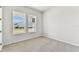 Bright bedroom with two windows offers a view of the neighborhood in this new home at 5979 Hidden Branch Dr, Apollo Beach, FL 33572