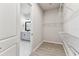 Walk-in closet with white wire shelving and an open doorway to a bathroom with a double vanity at 5979 Hidden Branch Dr, Apollo Beach, FL 33572