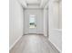 Inviting entryway with light wood flooring and bright, neutral walls at 5979 Hidden Branch Dr, Apollo Beach, FL 33572